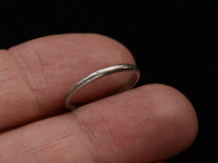 thumbnail of 1924 Patterned Platinum Band (shown hand for scale)