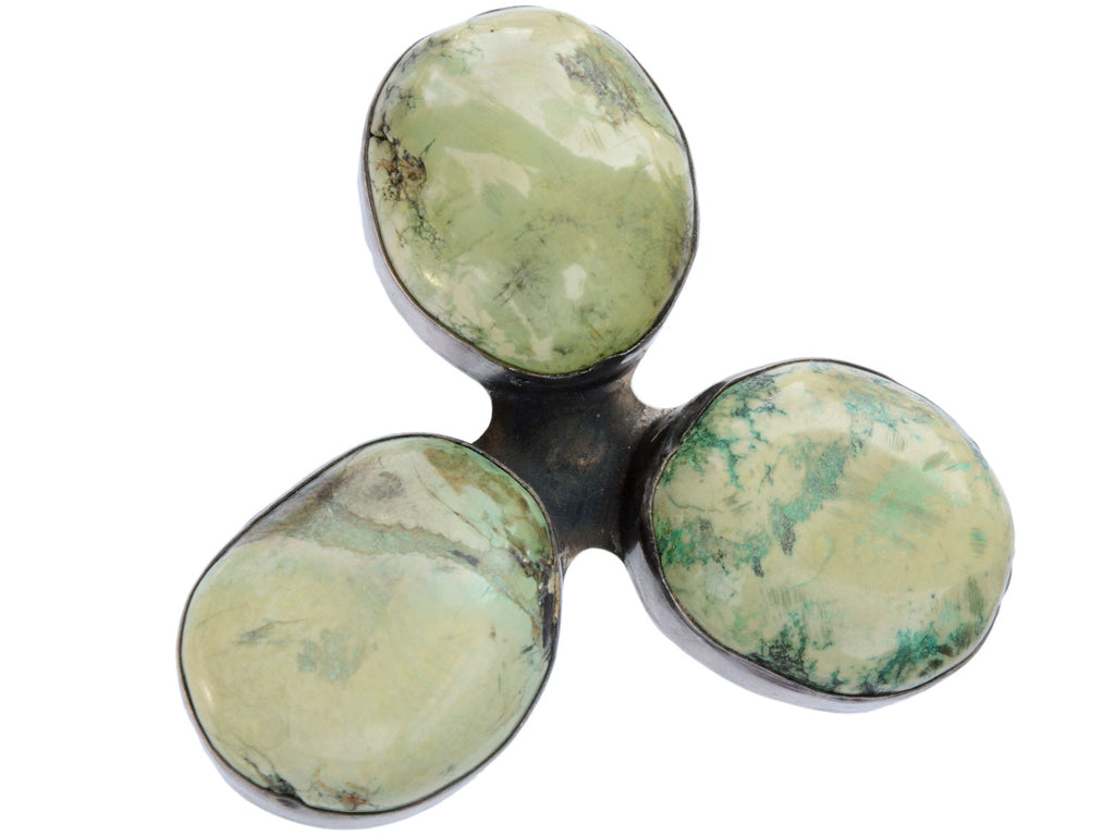 A large vintage c19980 brooch with three oval turquoise stones set in silver in a clover-like formation. (Shown on white background)