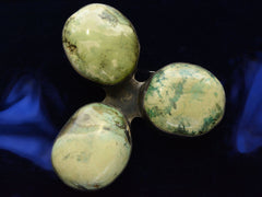 thumbnail of A large vintage c19980 brooch with three oval turquoise stones set in silver in a clover-like formation. (Shown on dark background)