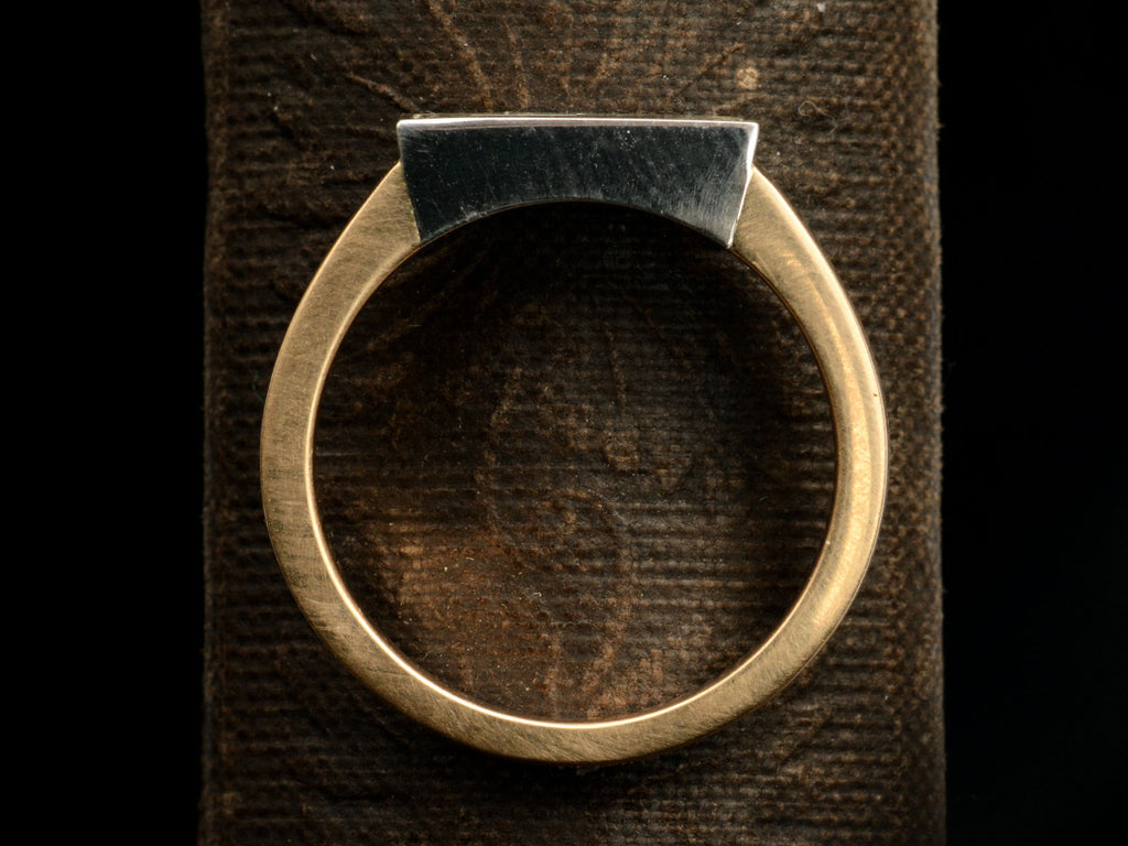 Flat profile side of EB Modern Diamond Engagement Ring with an Elongated 1.12ct Step Cut Shield Diamond in a Platinum Bezel with a Wide 18K Yellow Gold Shank (Shown on dark background)