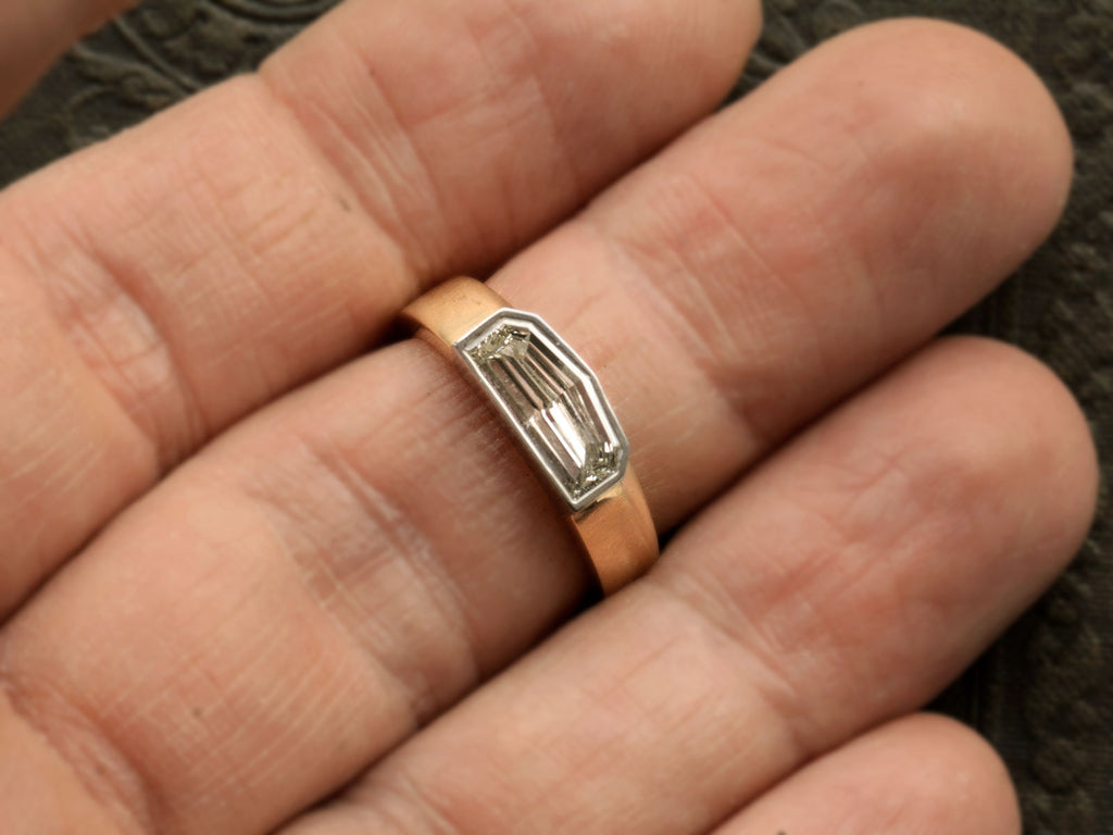 EB Modern Diamond Engagement Ring with an Elongated 1.12ct Step Cut Shield Diamond in a Platinum Bezel with a Wide 18K Yellow Gold Shank (Shown on hand for scale)