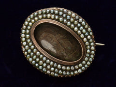thumbnail of 1810 Georgian Pearl Lace Pin with Brown Hair under Glass (shown on dark background)
