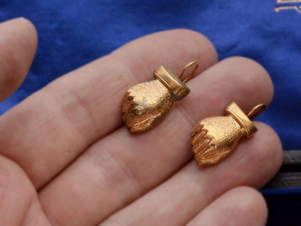 Pair of Victorian gold fist earrings (on hand for scale)