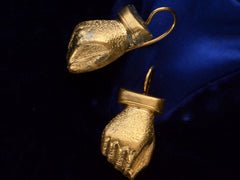 thumbnail of Angled view of pair of Victorian gold fist earrings (on dark background)