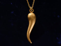 thumbnail of Vintage Italian cornicello horn charm in yellow gold, on dark blue background.