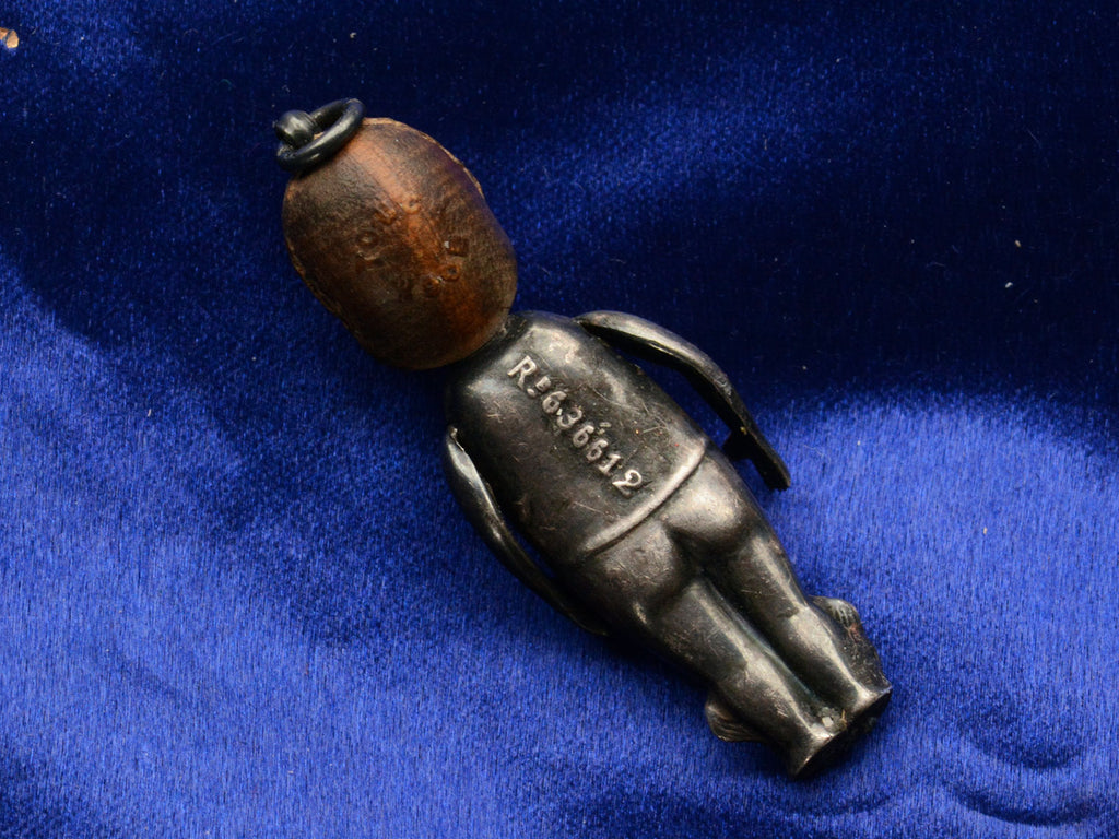 Reverse side of c1915 Kewpie Doll Charm with Oxidized Silver Body and Wooden Head (Registry Number on back reads R.636612)