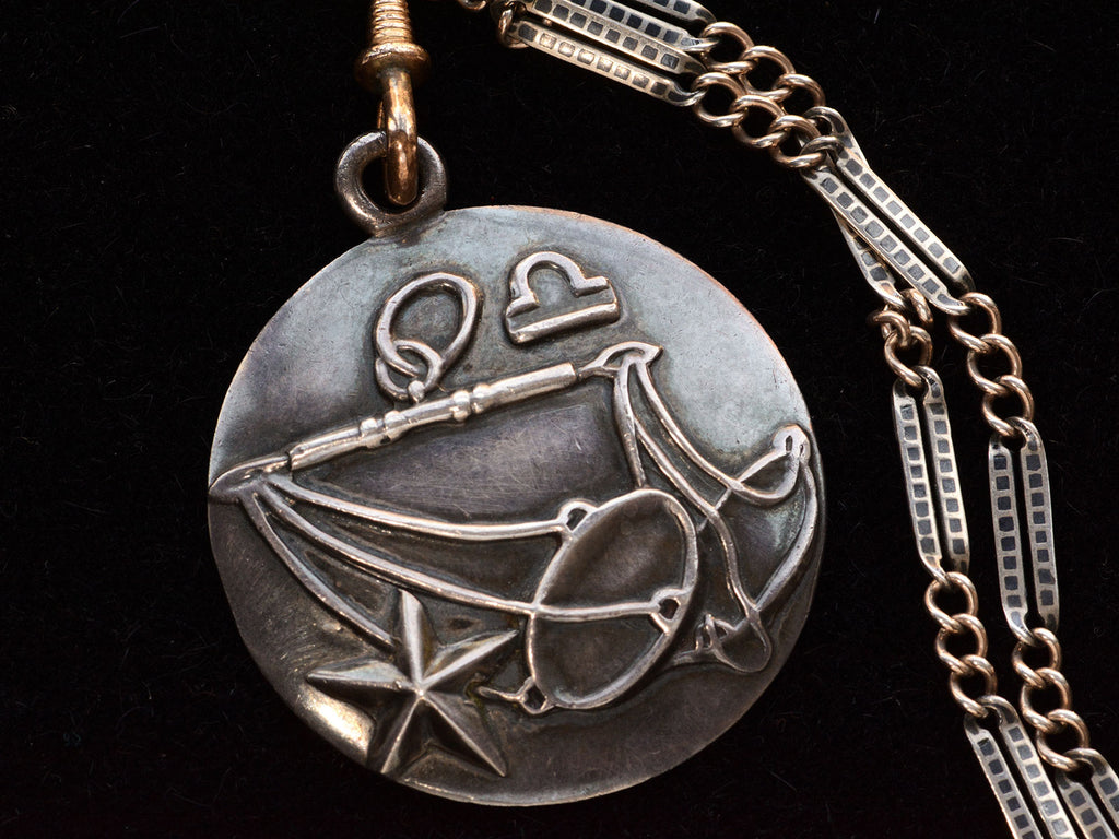 Vintage Margot de Taxco Silver Libra Pendant with Scales on Long Niello Chain (detail view of front of pendant on black background)