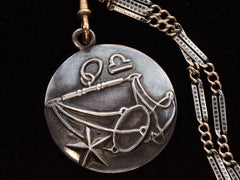 thumbnail of Vintage Margot de Taxco Silver Libra Pendant with Scales on Long Niello Chain (detail view of front of pendant on black background)