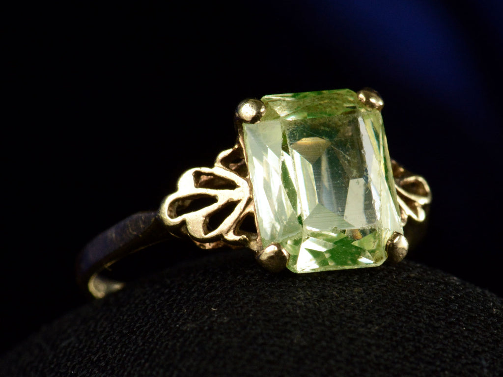 Left angle view of c1930 Rectangular Uranium Glass Ring with Filigreed Yellow Gold Mounting (on dark background)
