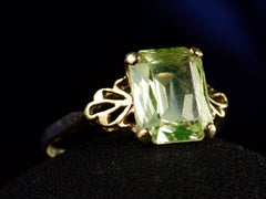 thumbnail of Left angle view of c1930 Rectangular Uranium Glass Ring with Filigreed Yellow Gold Mounting (on dark background)