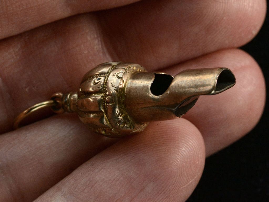 c1890 Gold Whistle Pendant (side view on hand for scale)