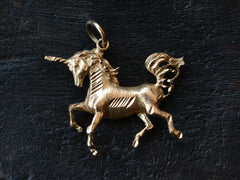 thumbnail of 1980s Gold Unicorn Charm (on black background)