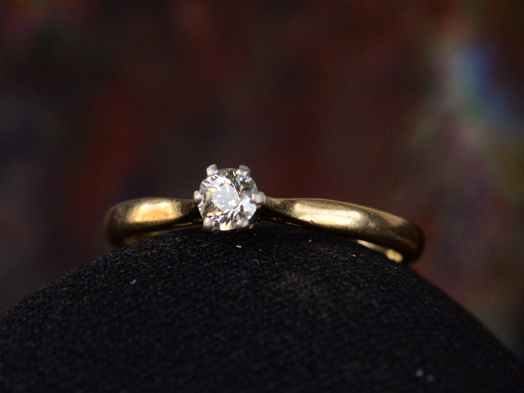 Angled front view of c1900 0.19ct Diamond Solitaire (on dark background)