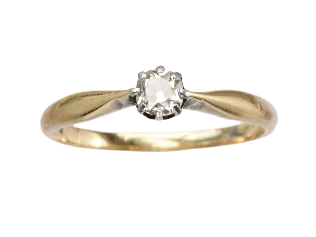 An antique ring with a 0.20ct old mine cut diamond set in a simple silver topped 14K yellow gold mounting, shown on white background.