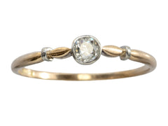 thumbnail of An antique Art Deco era yellow and white gold engagement ring with a bezel-set round 0.20ct old European cut diamond. Shown on white background.
