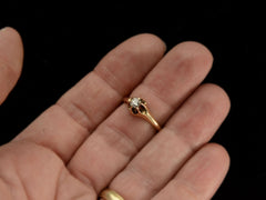 thumbnail of Front view of an antique Victorian solitaire engagement ring with a round diamond set in a six pronged rosy-yellow gold belcher mounting. Shown on hand.