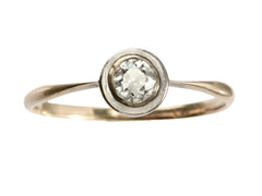 thumbnail of An antique Edwardian era engagement ring with a round diamond in a simple silver topped rosy-yellow gold mounting, shown on white background.
