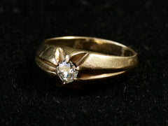 thumbnail of Right angled view of wide antique men's ring with cushion shaped old cut white diamonds set in yellow gold, shown on dark background.