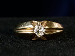 thumbnail of Front profile view of wide antique men's ring with cushion shaped old cut white diamonds set in yellow gold, shown on dark background.