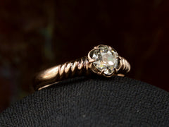 thumbnail of Left angled view of Victorian solitaire ring with a square old mine cut diamond set in a wide striped rose gold setting, shown on dark background.