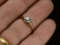 thumbnail of An antique engagement ring with a 0.75ct old European cut diamond set in a detailed 14K rose gold mounting, shown on finger.