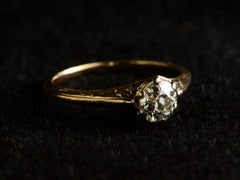 thumbnail of Angled view of antique engagement ring with a 0.75ct old European cut diamond set in a detailed 14K rose gold mounting, shown on dark background.