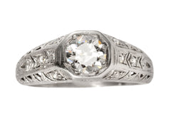 thumbnail of A c1920 Art Deco engagement ring with a round white diamond in a wide filigreed platinum mounting (shown on white background)