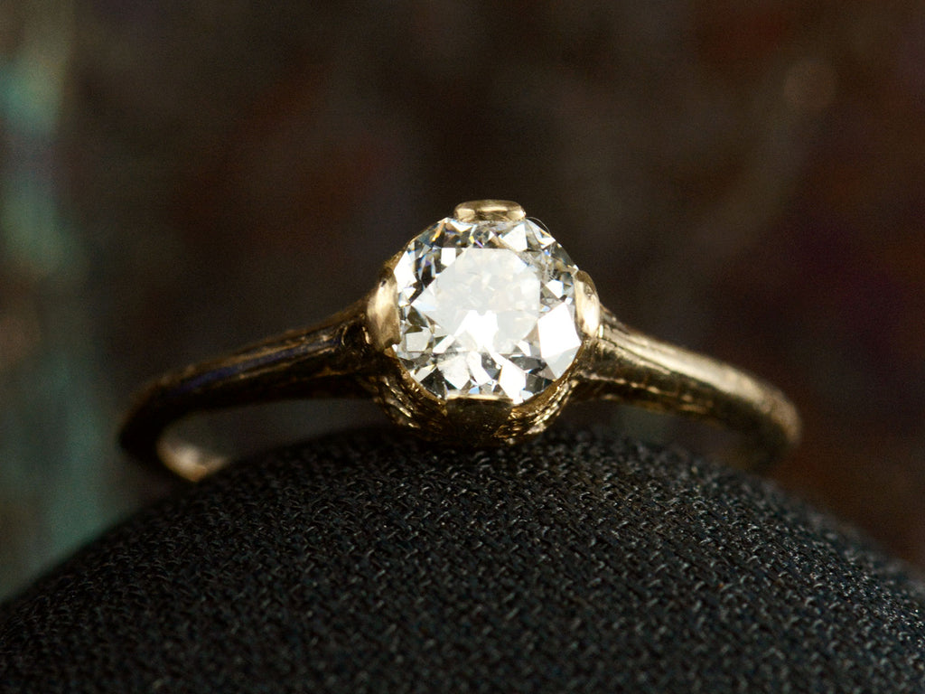 Front view of c1920 Art Deco yellow gold engagement ring with a 0.64ct round diamond (on dark background)