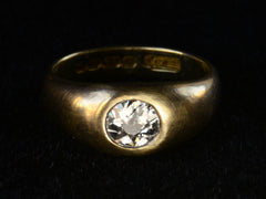 thumbnail of Elevated front view of a wide rounded antique yellow gold ring with a flush-set old European cut diamond, shown on dark background.