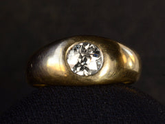 thumbnail of Front profile view of a wide rounded antique yellow gold ring with a flush-set old European cut diamond, shown on dark background.
