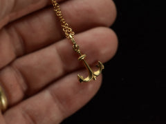 thumbnail of A vintage 14K yellow gold anchor charm on a cable chain, shown on hand. A mark on the bale is stamped "Italy"