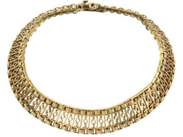 A c1880 French 18K yellow gold bracelet with filigreed links, shown on white background