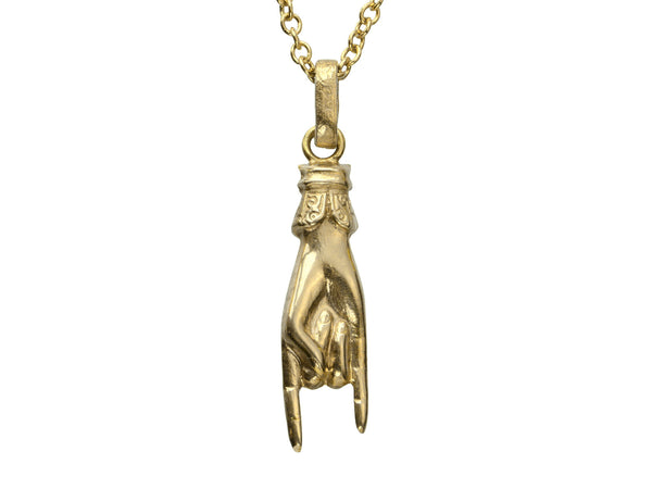 A vintage gold hand charm on a chain, gesturing the sign of the horns, shown on white background. "750" stamp visible on bale.