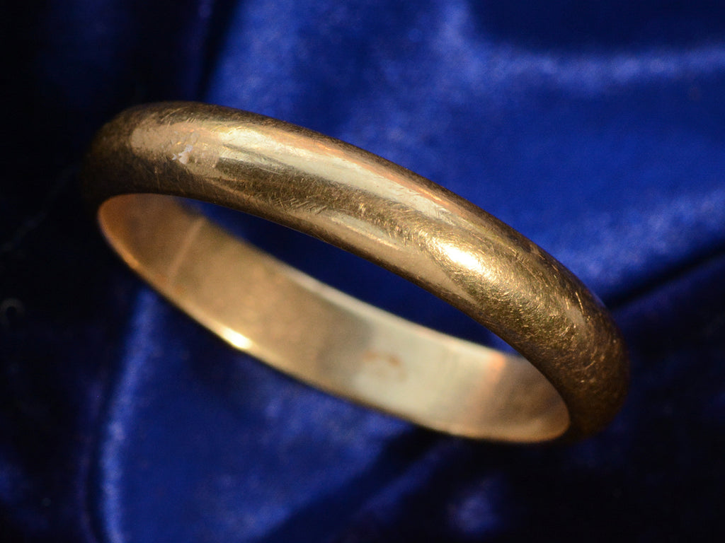 Angled view of c1950 4.0mm 18K Yellow Gold Wedding Band (on dark blue background)