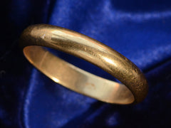 thumbnail of Angled view of c1950 4.0mm 18K Yellow Gold Wedding Band (on dark blue background)