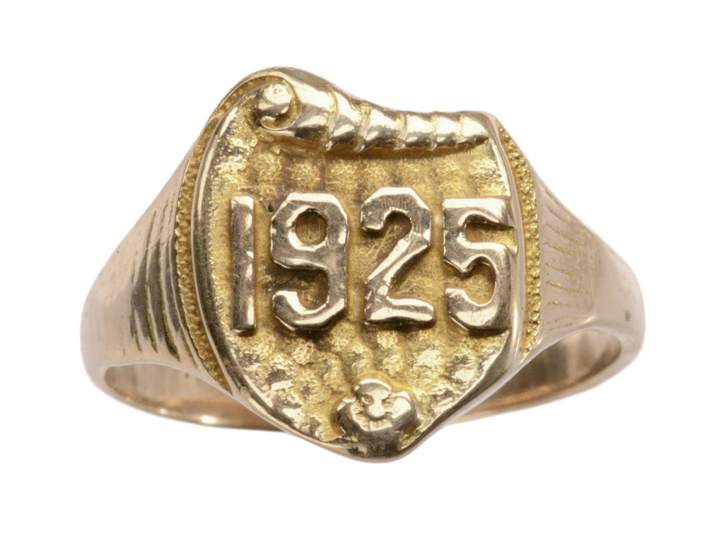 Art Deco yellow gold signet ring with the year "1925" on a shield shaped signet face. Shown on white background.