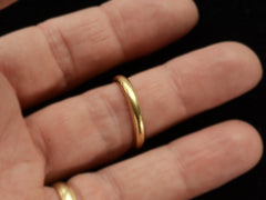 thumbnail of A rounded 18K yellow gold wedding band shown on finger.