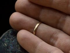thumbnail of Narrow slightly rounded 10k yellow gold band, shown on white background. Shown on finger.