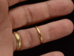 thumbnail of A narrow slightly rounded 22K yellow gold band, shown on finger.