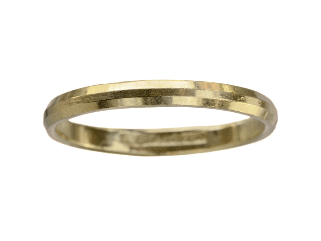 A narrow 18K yellow gold band with beveled edges, shown on white background.