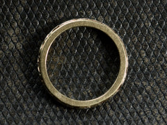 thumbnail of Side profile of a yellow c1920 Art Deco wedding band with white gold decoration on the outside face, shown on dark textured background.
