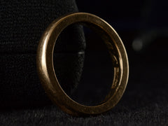 thumbnail of Angled side view of a heavy antique wedding band in a rosy-yellow gold measuring 3.2mm wide. Shown on dark background. A "14K" stamp is visible inside as well as an indecipherable inscription.