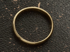thumbnail of Side profile of a patinated 14k yellow gold men's wedding band with a slightly rounded profile, shown on dark background.