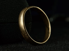 thumbnail of Angled view of a patinated 14k yellow gold men's wedding band with a slightly rounded profile, shown on dark background.
