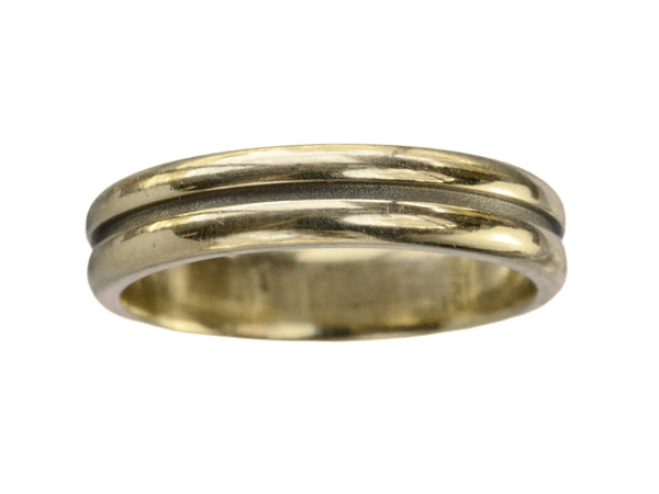A medium width vintage 14k yellow gold wedding band with a groove cut down the middle, shown on white background.