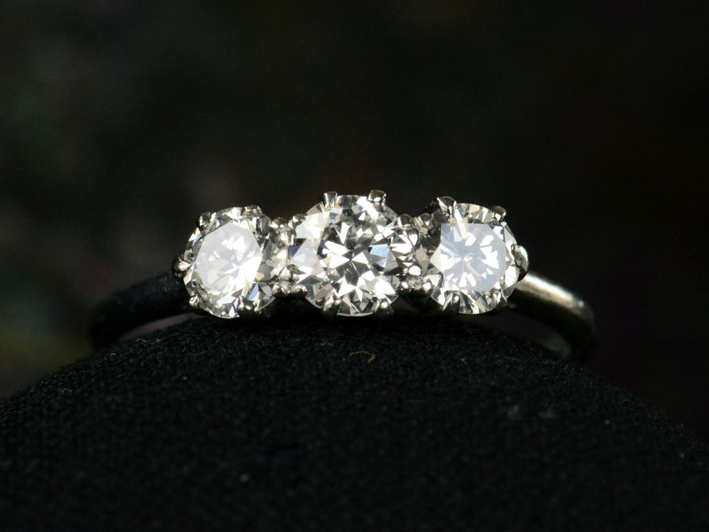 Front profile of simple c1920 Three Diamond Ring in Platinum (on dark background)