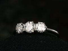 thumbnail of Angled front view of simple c1920 Three Diamond Ring in Platinum (on dark background)