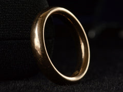 thumbnail of Angled view of rounded 4.0mm wide antique rosy-yellow gold wedding band, shown on black background.