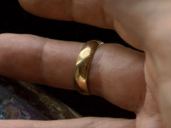thumbnail of A 5.5mm wide vintage men's wedding band with a modeled surface, shown on finger. 
