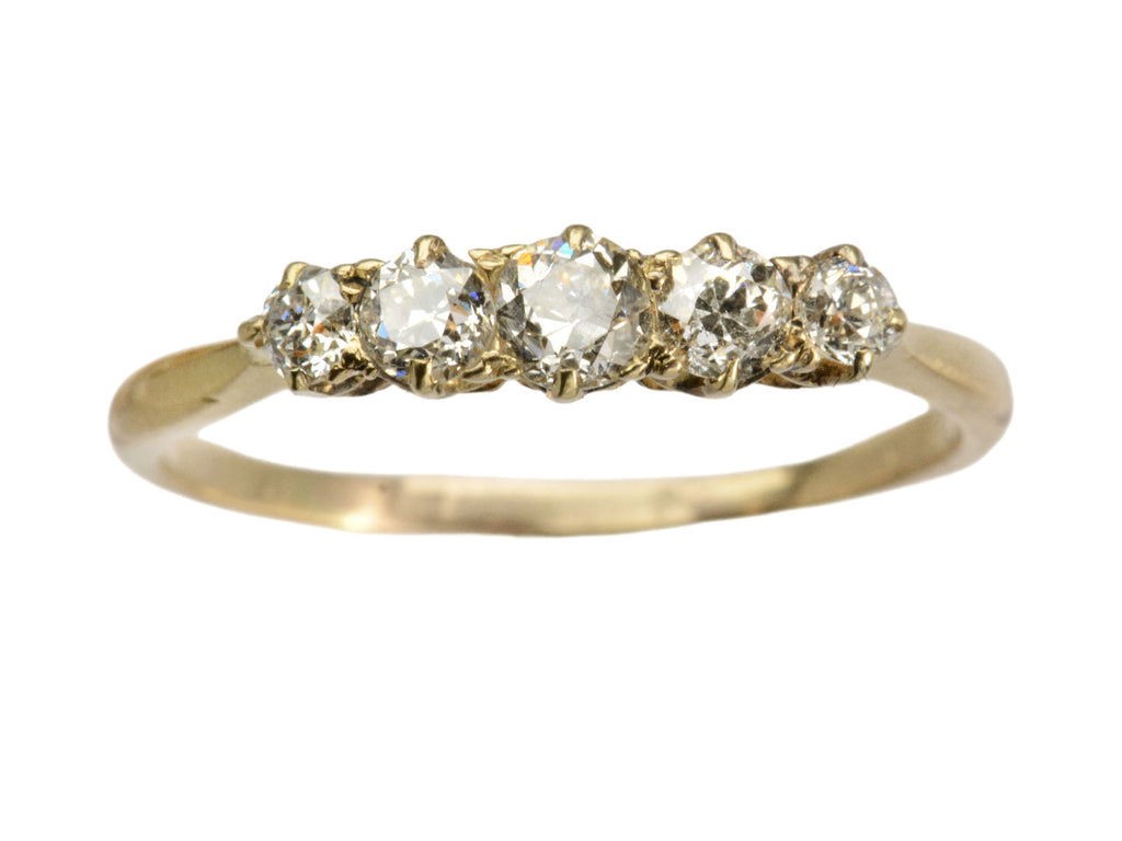 Antique c1900 ring with five small diamonds set in a row in 18K yellow gold. Shown on white background.
